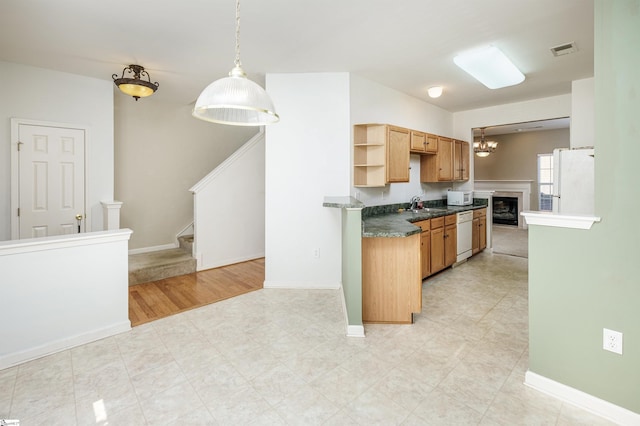 kitchen with light hardwood / wood-style floors, sink, hanging light fixtures, and white appliances