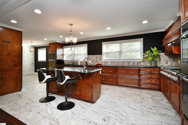 kitchen with tasteful backsplash, a chandelier, stainless steel appliances, and a kitchen breakfast bar