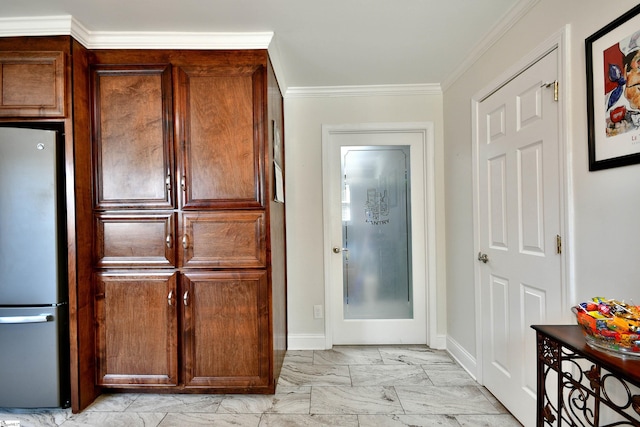 kitchen with ornamental molding and stainless steel refrigerator