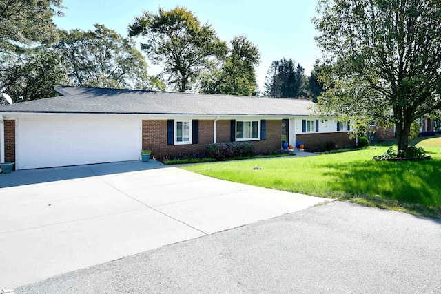 ranch-style home with a front yard and a garage