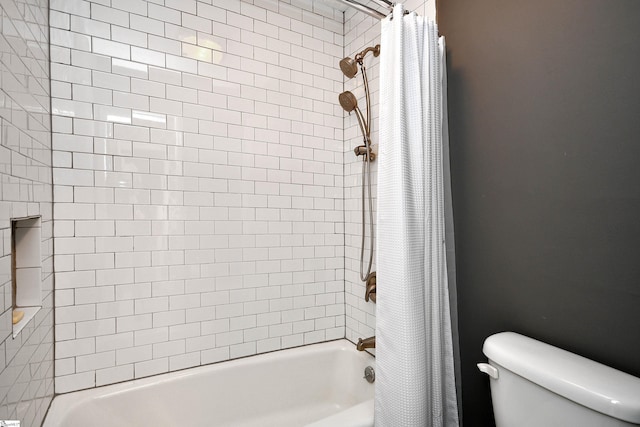 bathroom with shower / bath combo with shower curtain and toilet