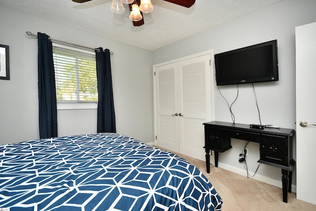 carpeted bedroom featuring a closet, ceiling fan, and a textured ceiling