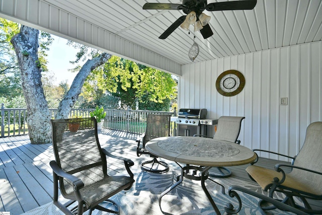 wooden terrace with ceiling fan and grilling area