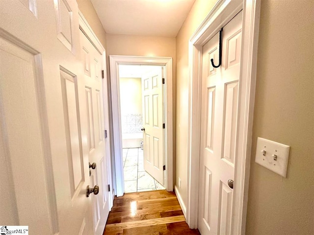 corridor featuring hardwood / wood-style floors