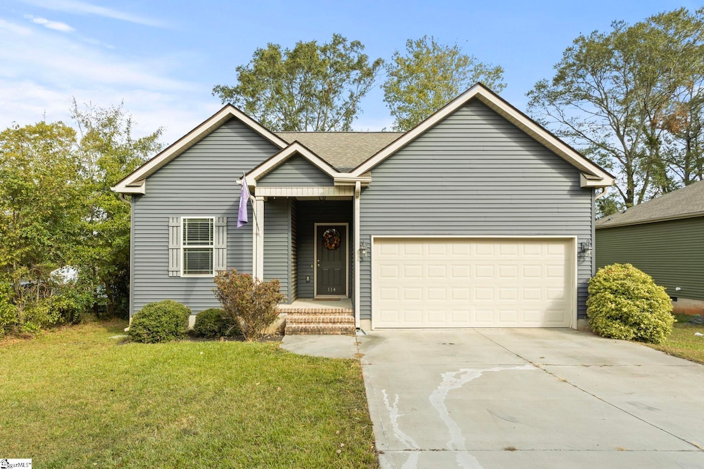 view of front of property with a front lawn and a garage