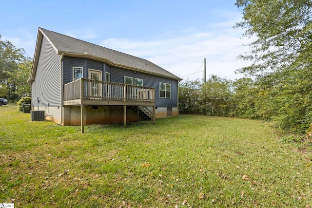 rear view of house with a wooden deck, a lawn, and cooling unit