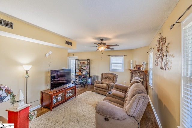 living room with hardwood / wood-style floors and ceiling fan