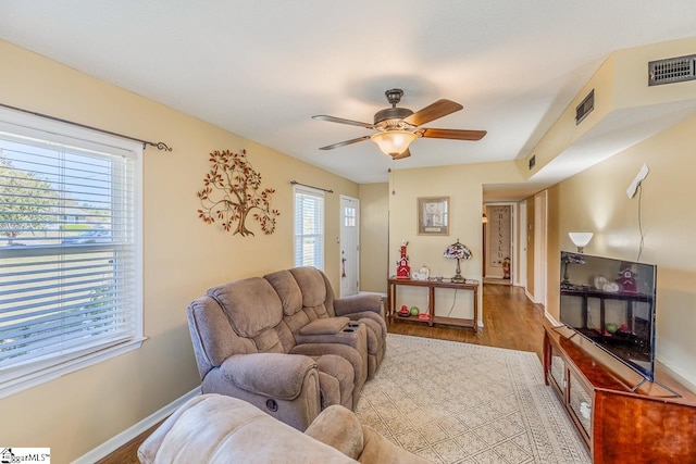 living room featuring hardwood / wood-style flooring and ceiling fan