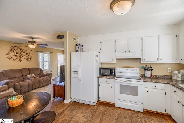 kitchen with white appliances, ceiling fan, hardwood / wood-style floors, and white cabinets