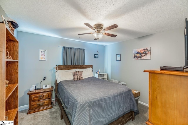 carpeted bedroom with a textured ceiling and ceiling fan