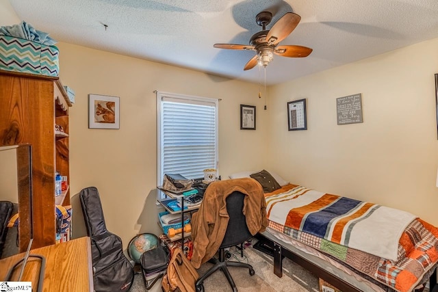 bedroom with a textured ceiling, light colored carpet, and ceiling fan