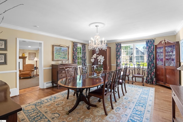 dining room featuring light hardwood / wood-style floors, crown molding, a baseboard heating unit, and a chandelier