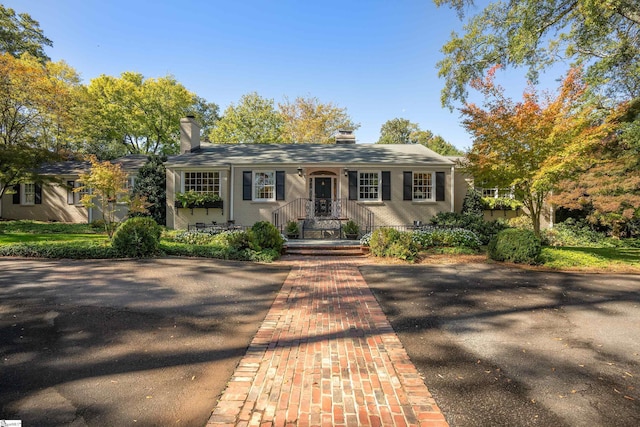 single story home featuring covered porch