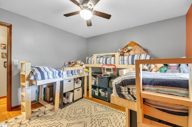 bedroom with light hardwood / wood-style floors and ceiling fan