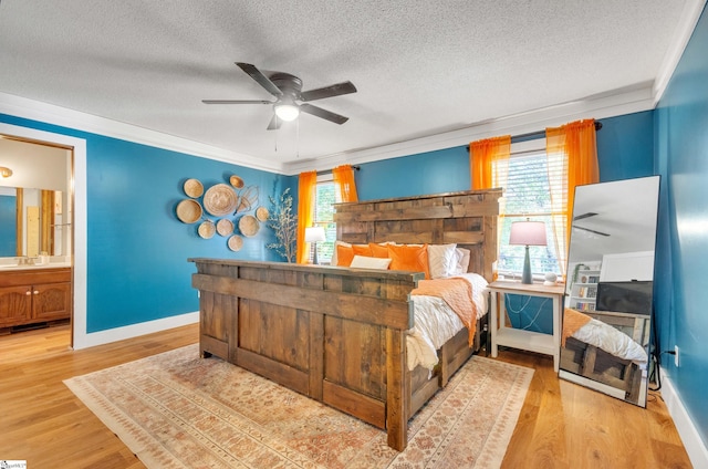 bedroom featuring multiple windows, ensuite bathroom, and ceiling fan