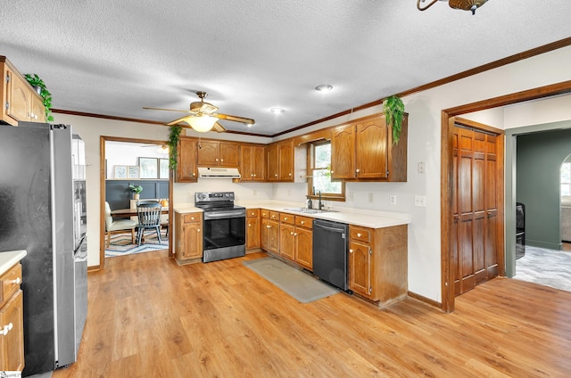 kitchen with appliances with stainless steel finishes, light hardwood / wood-style flooring, sink, and crown molding