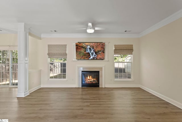 unfurnished living room with ornamental molding, hardwood / wood-style flooring, ornate columns, and ceiling fan