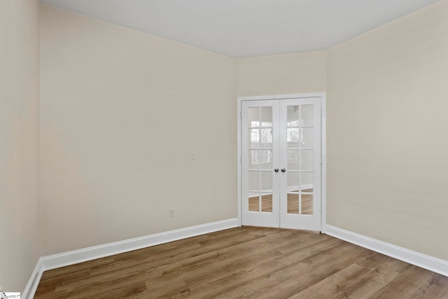 empty room featuring french doors and light wood-type flooring