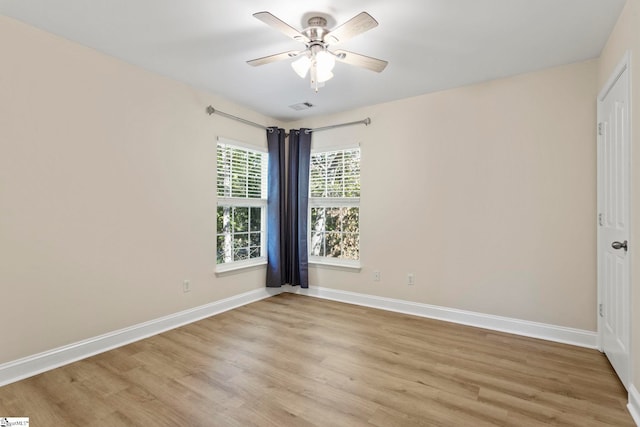 empty room with light hardwood / wood-style floors and ceiling fan