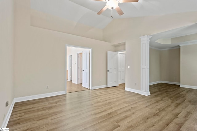 unfurnished bedroom featuring decorative columns, ceiling fan, lofted ceiling, and light hardwood / wood-style flooring