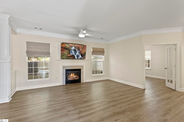 unfurnished living room featuring crown molding, wood-type flooring, and ceiling fan