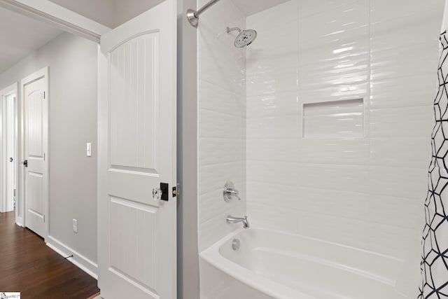 bathroom featuring hardwood / wood-style floors and shower / tub combo