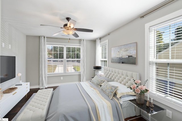 bedroom with dark hardwood / wood-style floors and ceiling fan