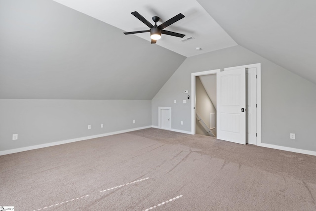 additional living space featuring ceiling fan, lofted ceiling, and carpet floors