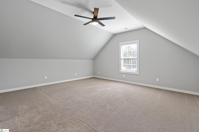 additional living space with ceiling fan, carpet, and lofted ceiling