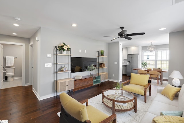 living room featuring hardwood / wood-style floors and ceiling fan