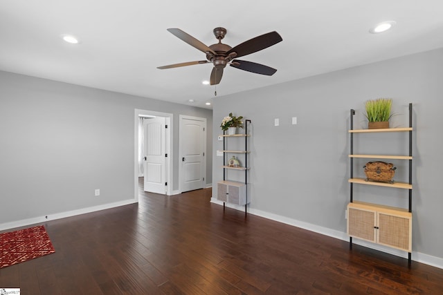 empty room featuring ceiling fan and dark hardwood / wood-style floors