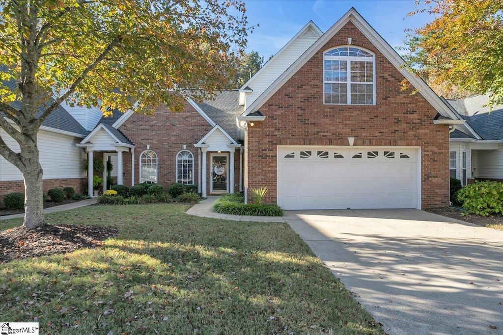 view of front property featuring a front yard and a garage