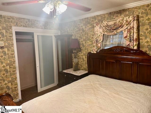 bedroom featuring a closet, ceiling fan, and ornamental molding