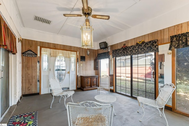 unfurnished sunroom featuring ceiling fan