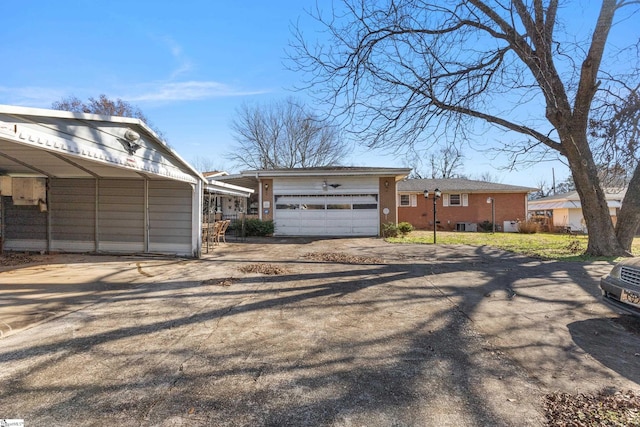 view of front facade with a garage and a carport