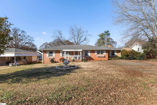 rear view of property featuring a lawn