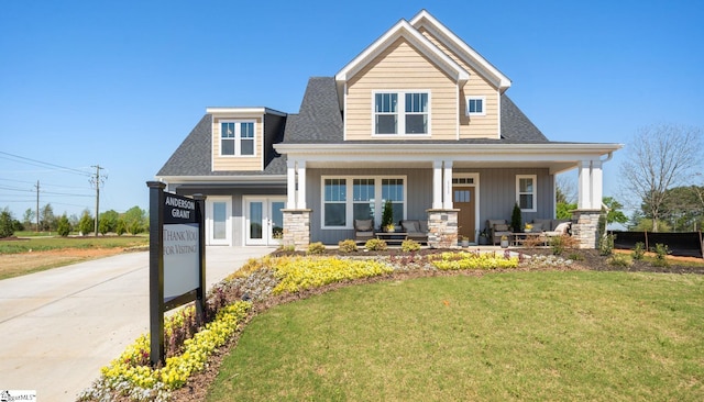 view of front of property with covered porch and a front lawn