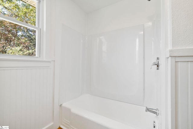 bathroom featuring shower / tub combination and a healthy amount of sunlight