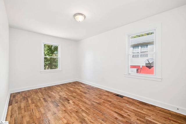 unfurnished room featuring hardwood / wood-style flooring