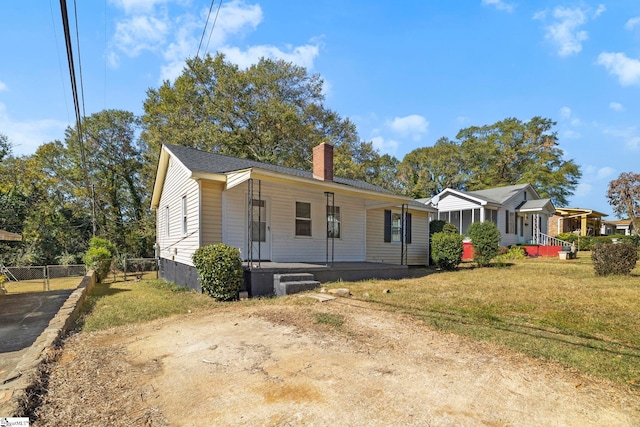 view of front of property with a front yard and covered porch