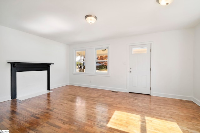 unfurnished living room with light hardwood / wood-style flooring