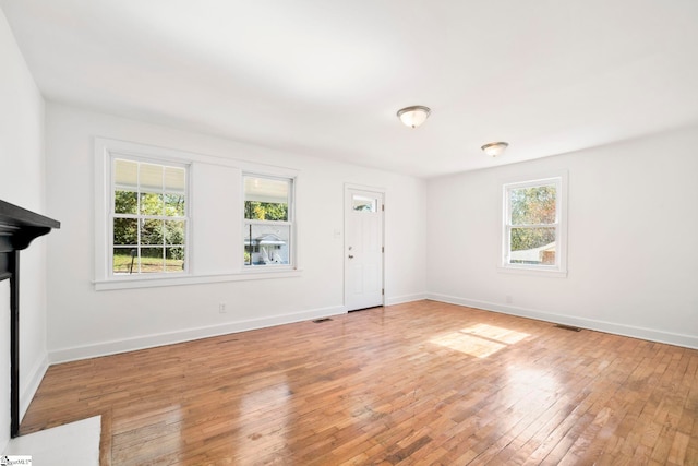 interior space with wood-type flooring and a healthy amount of sunlight