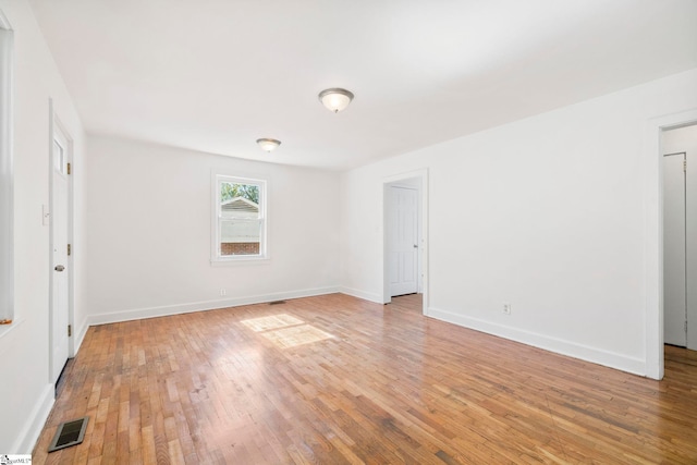 unfurnished room featuring hardwood / wood-style flooring