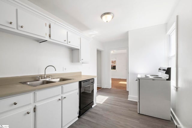 kitchen featuring white cabinets, black dishwasher, a healthy amount of sunlight, light hardwood / wood-style flooring, and sink