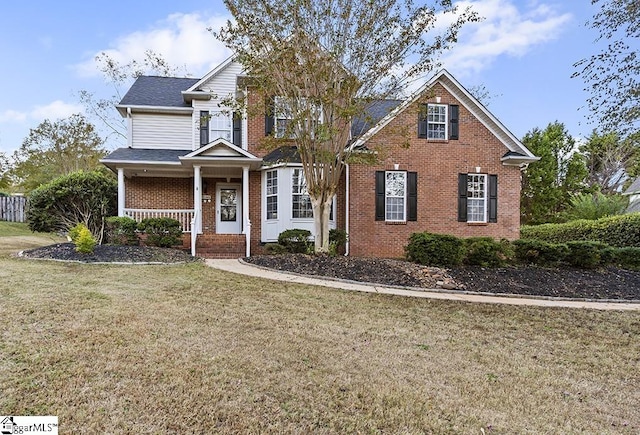 view of property featuring a front lawn and a porch