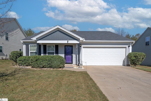 view of front of home featuring a front yard and a garage