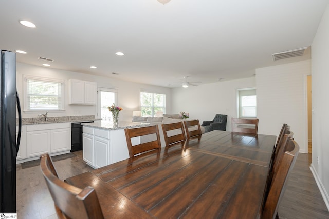 dining room with dark wood-type flooring, ceiling fan, and sink