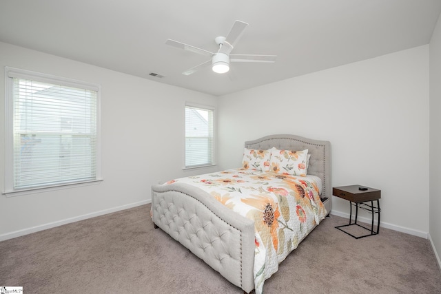 bedroom featuring light carpet and ceiling fan