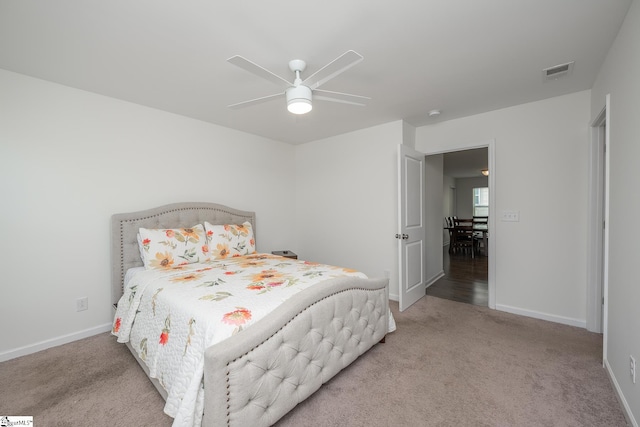 bedroom featuring light colored carpet and ceiling fan