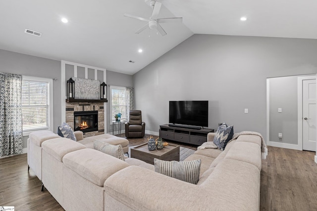 living room featuring ceiling fan, a fireplace, high vaulted ceiling, and dark hardwood / wood-style floors